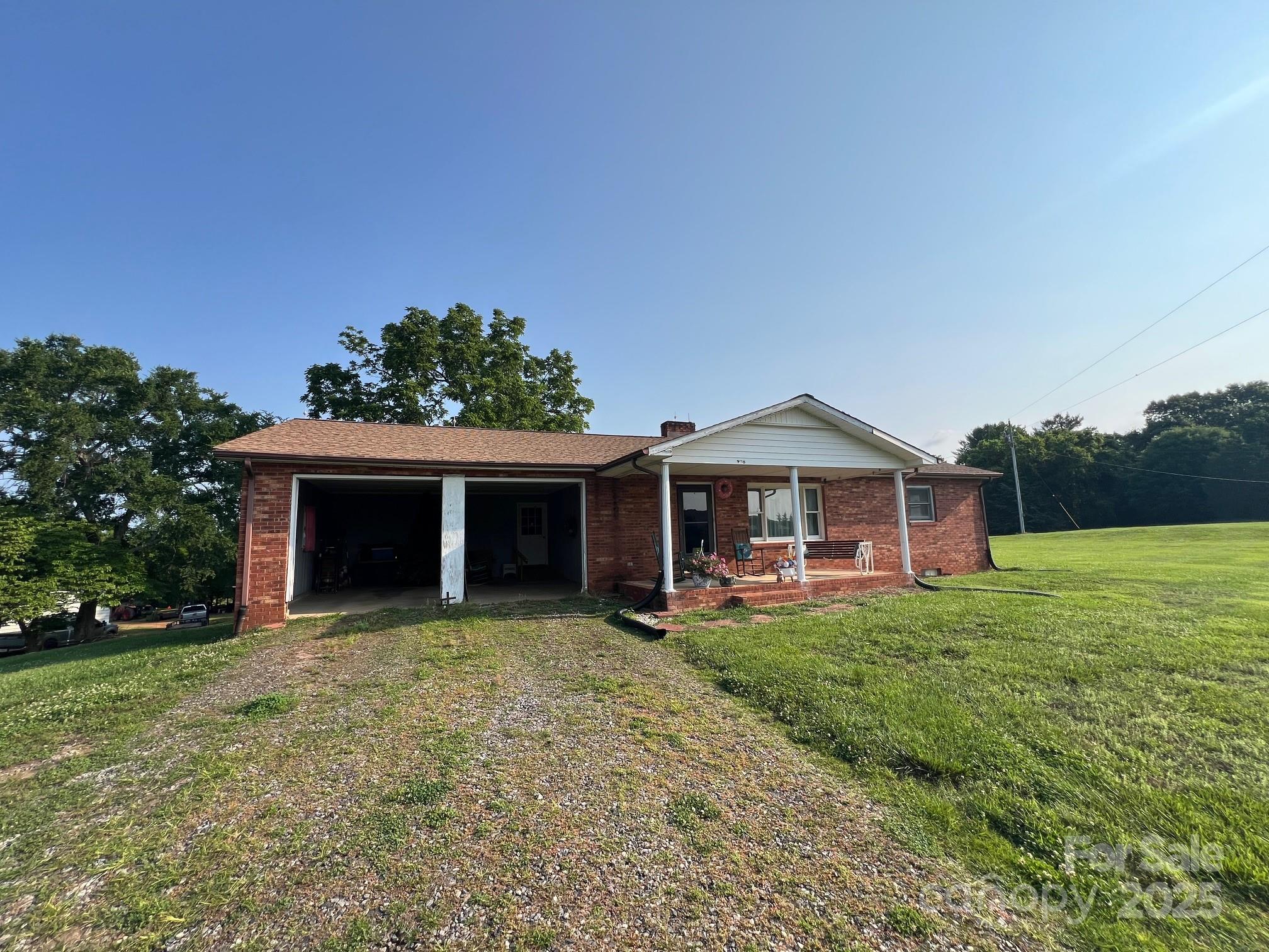 906 East Monbo Road Statesville, NC 28677 - Photo 16 of 30 a view of a house with backyard porch and garden