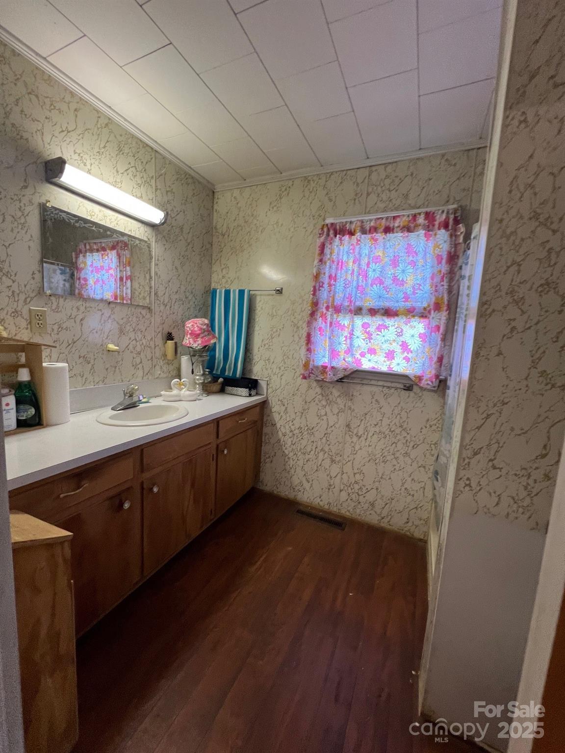 906 East Monbo Road Statesville, NC 28677 - Photo 20 of 30 a kitchen with sink cabinets and wooden floor