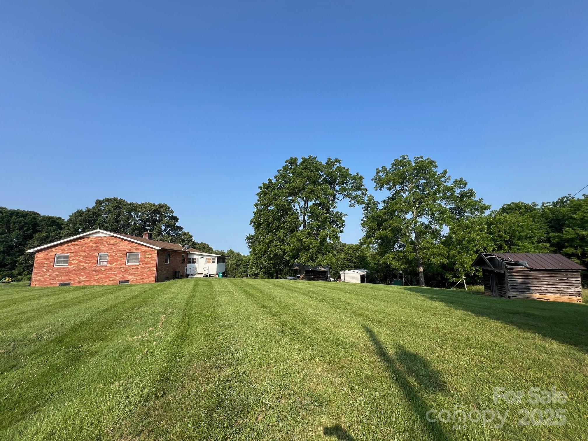 906 East Monbo Road Statesville, NC 28677 - Photo 24 of 30 a view of a garden with a building in the background