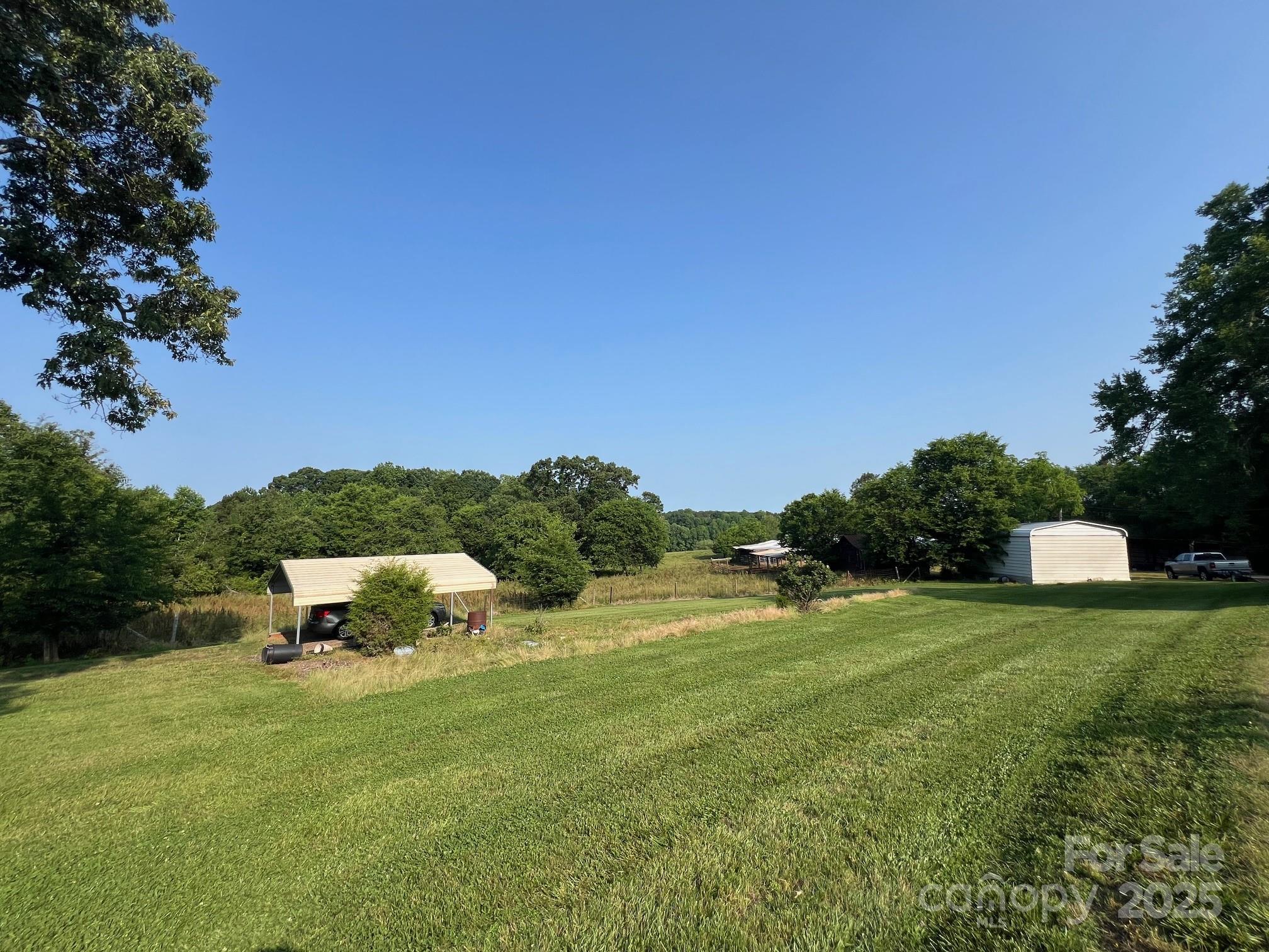 906 East Monbo Road Statesville, NC 28677 - Photo 26 of 30 a view of a garden with a building in the background