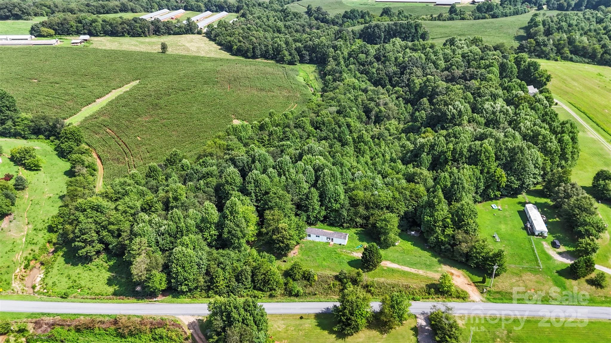 906 East Monbo Road Statesville, NC 28677 - Photo 4 of 30 a view of a garden with a building in the background