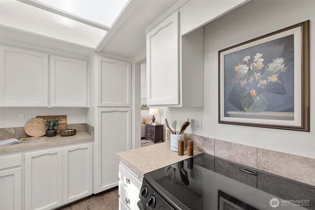 a kitchen with a sink a cabinets and window