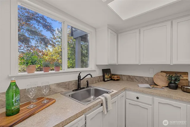 a bedroom with a bed and a dresser next to a window