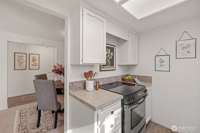 a kitchen with a sink stove and cabinets