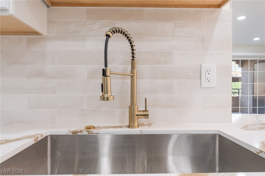 2200 South Fort Apache Road, Unit 1101 Las Vegas, NV 89117 - Photo 14 of 42 Kitchen view of light stone counters, tasteful backsplash, and recessed lighting