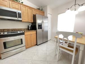 18856 Argosy Drive, Unit C Boca Raton, FL 33496 - Photo 28 of 62 a kitchen with stainless steel appliances granite countertop a stove a microwave and a refrigerator