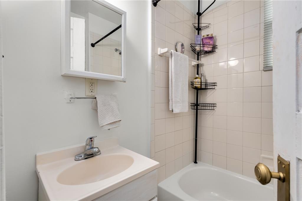 1323 La France Street Northeast, Unit 2 Atlanta, GA 30307 - Photo 13 of 25 a bathroom with a sink a toilet and shower