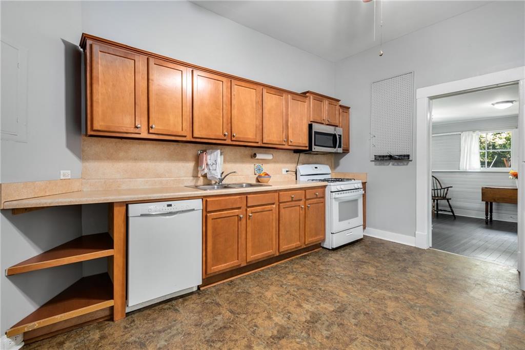 1323 La France Street Northeast, Unit 2 Atlanta, GA 30307 - Photo 16 of 25 a kitchen with a sink cabinets and a window