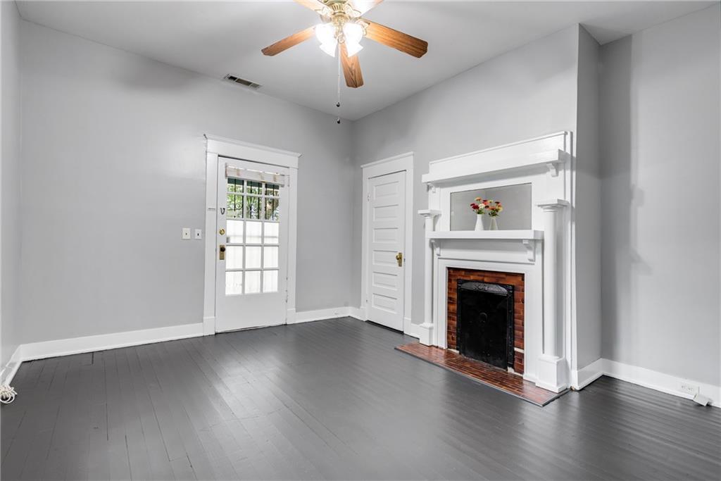 1323 La France Street Northeast, Unit 2 Atlanta, GA 30307 - Photo 8 of 25 an empty room with wooden floor fireplace and windows