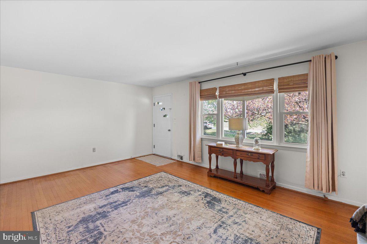 2447 Rittenour Road Edinburg, VA 22824 - Photo 8 of 40 an empty room with wooden floor and windows
