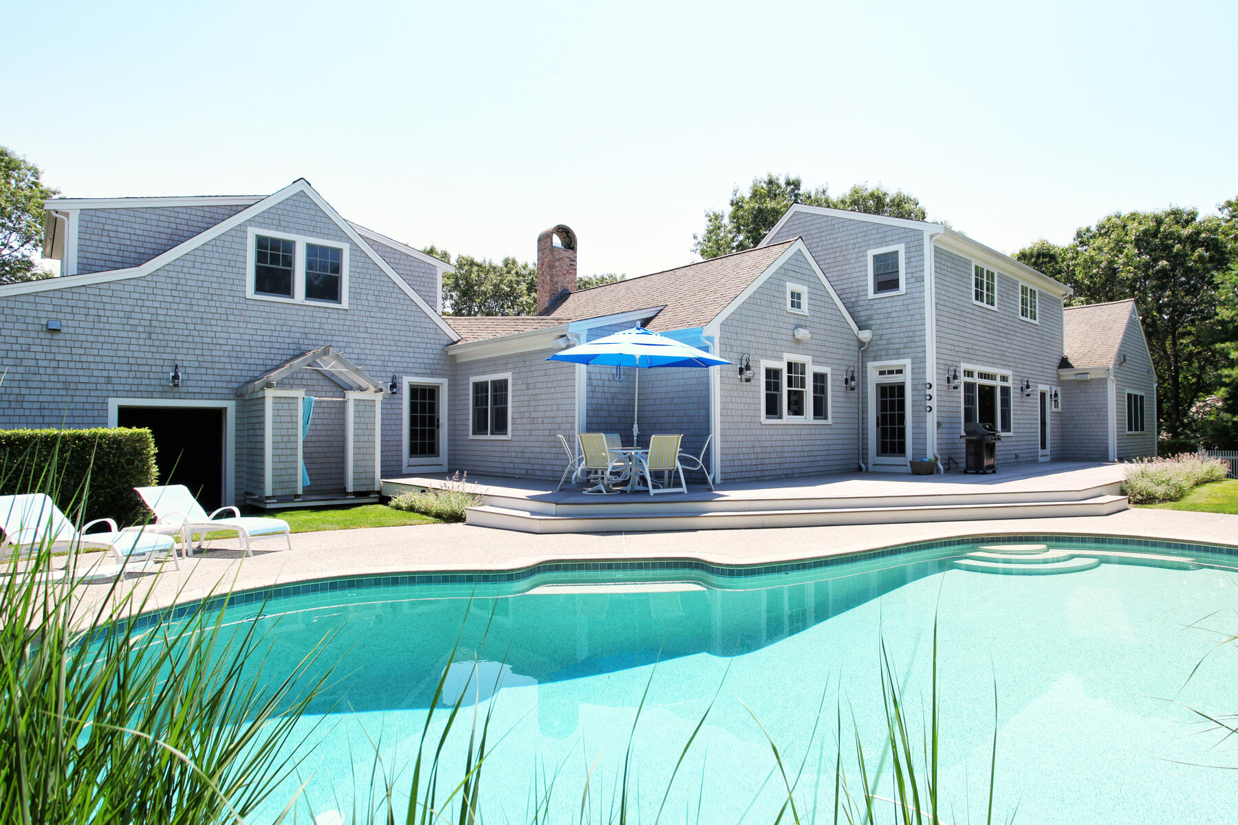 160 Cedar Tree Neck Road Marstons Mills, MA 02648 - Photo 3 of 44 a front view of a house with swimming pool having outdoor seating
