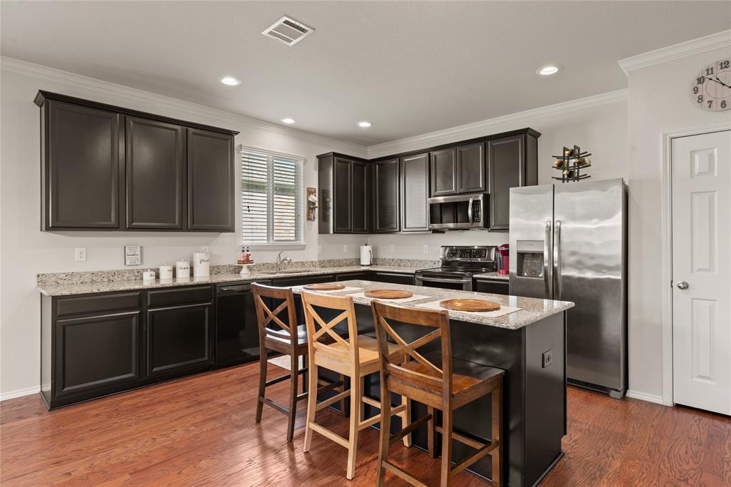 537 Running Water Trail Fort Worth, TX 76131 - Photo 15 of 31 a kitchen with stainless steel appliances granite countertop a stove refrigerator sink microwave and cabinets