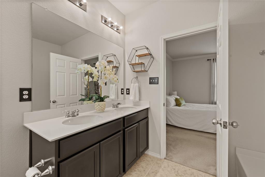 537 Running Water Trail Fort Worth, TX 76131 - Photo 20 of 31 a en suite bathroom with a double vanity sink mirror and