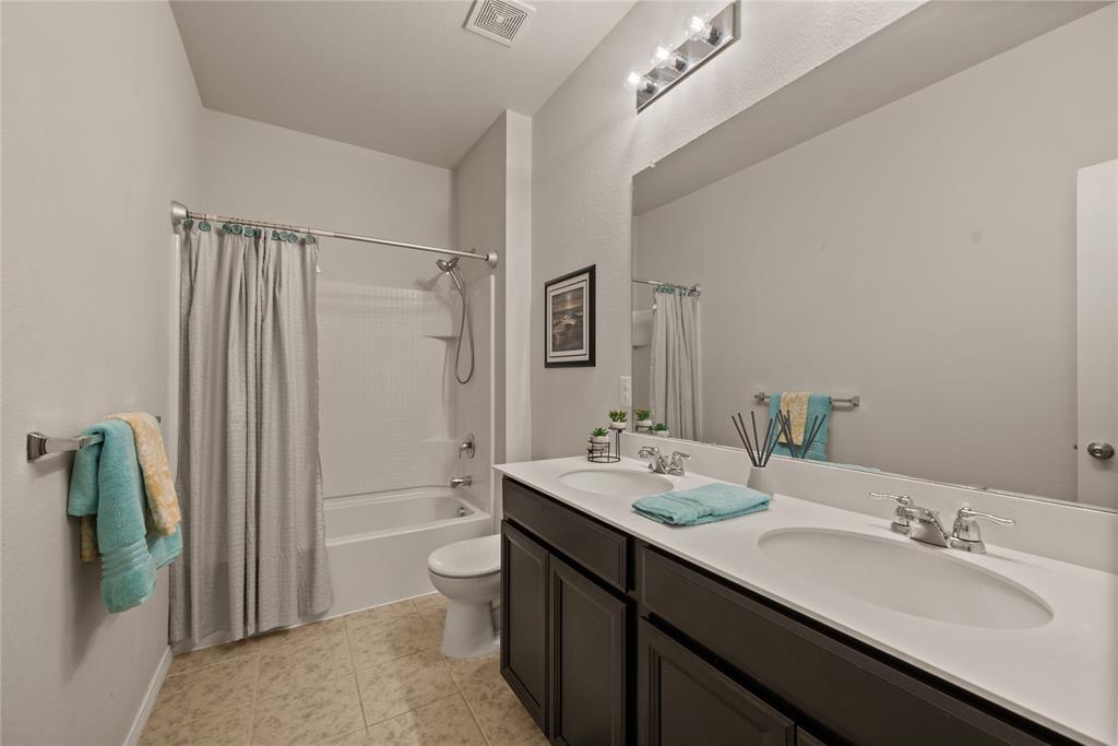 537 Running Water Trail Fort Worth, TX 76131 - Photo 22 of 31 a bathroom with a double vanity sink toilet and shower