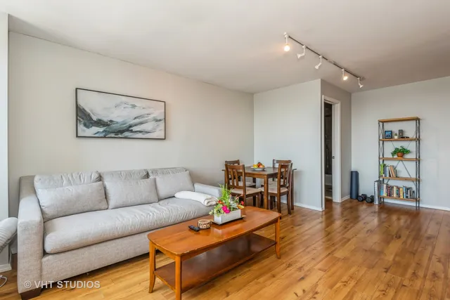 a view of a livingroom with an empty room and wooden floor