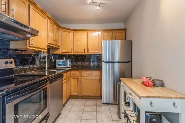 a kitchen with appliances cabinets and a sink