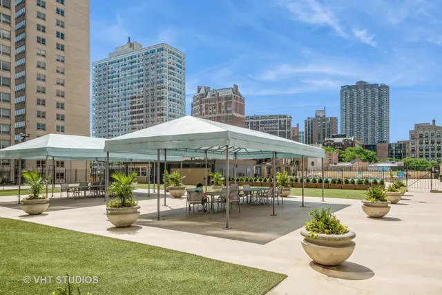 a view of a swimming pool with a table and chairs under an umbrella
