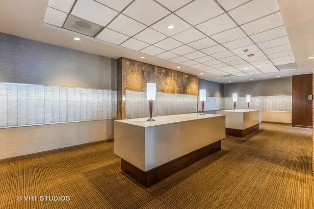 a lobby with furniture and floor to ceiling window