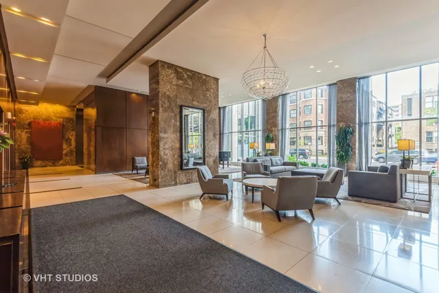 a living room with furniture a chandelier and a dining table