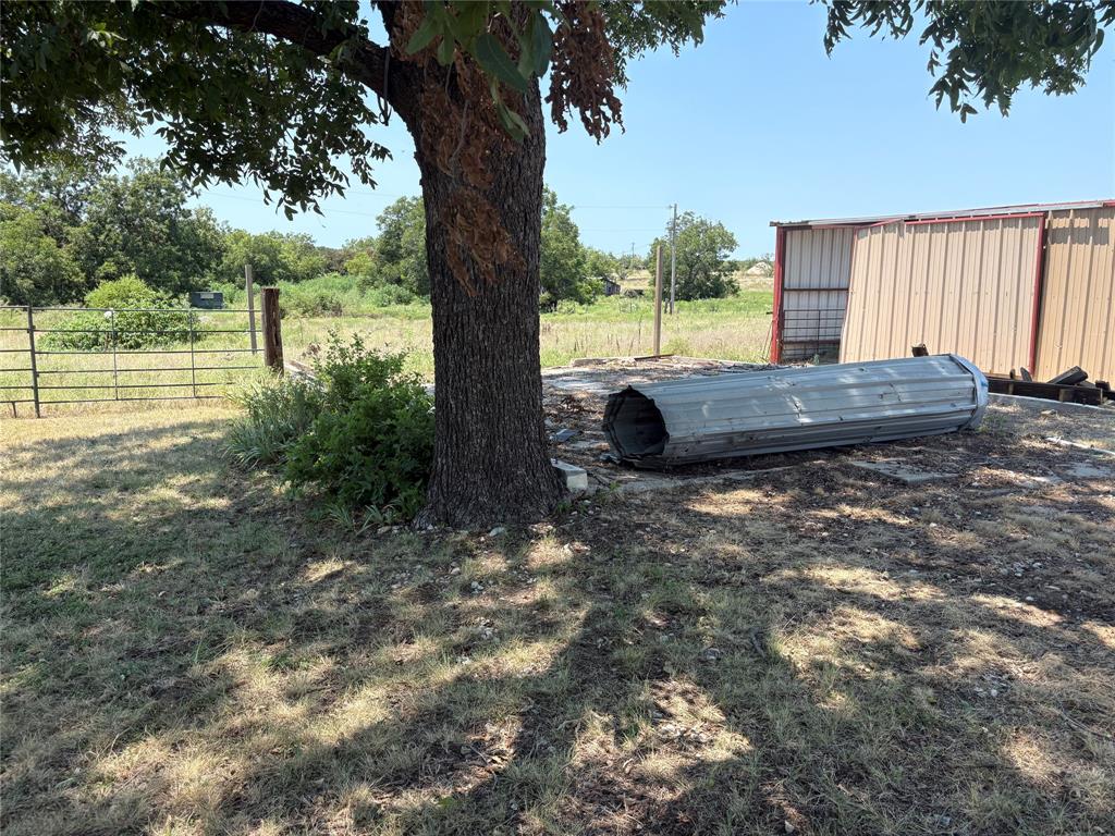 912 Highway 36 W Rising Star Tx 76471 West Rising Star, TX 76471 - Photo 14 of 28 a view of a yard in front of a house with a large tree