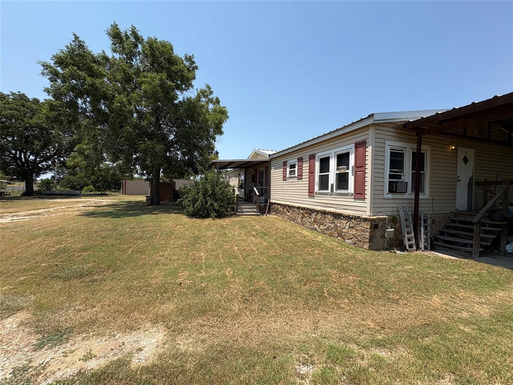 912 Highway 36 W Rising Star Tx 76471 West Rising Star, TX 76471 - Photo 19 of 28 a front view of a house with a yard