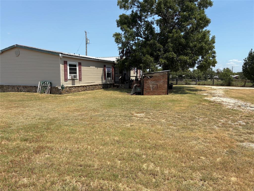 912 Highway 36 W Rising Star Tx 76471 West Rising Star, TX 76471 - Photo 9 of 28 a view of a house with a yard and garage