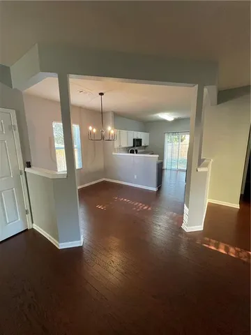a view of a room with wooden floor and windows