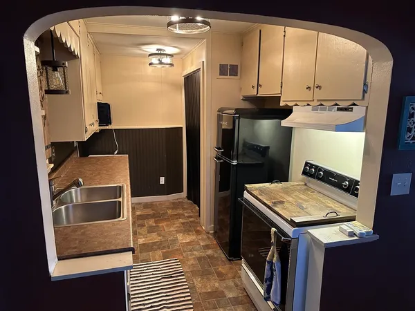 a kitchen with a sink and refrigerator