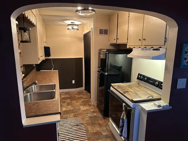a kitchen with a sink and refrigerator