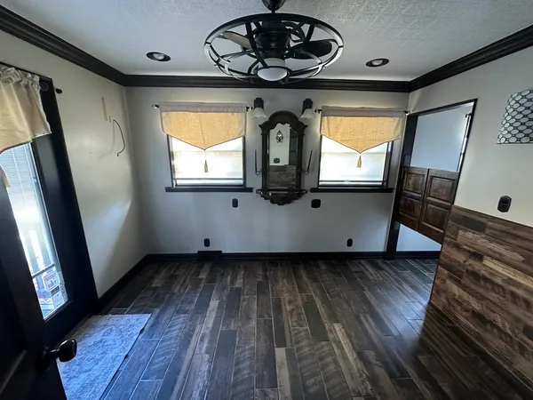 a view of a hallway with wooden floor