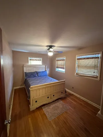 a view of a room with wooden floor closet and windows