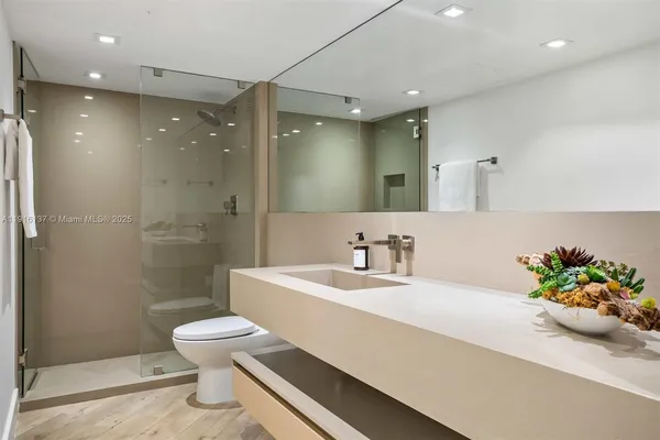 a bedroom with a large bed and a flat screen tv