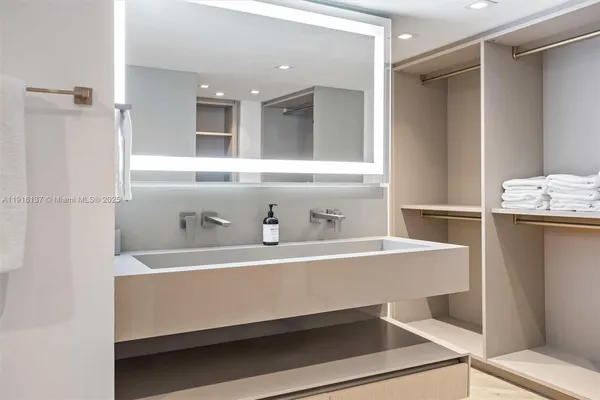 a kitchen with stainless steel appliances kitchen island granite countertop a refrigerator and a stove