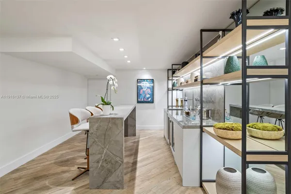 a living room with furniture a flat screen tv and a large window