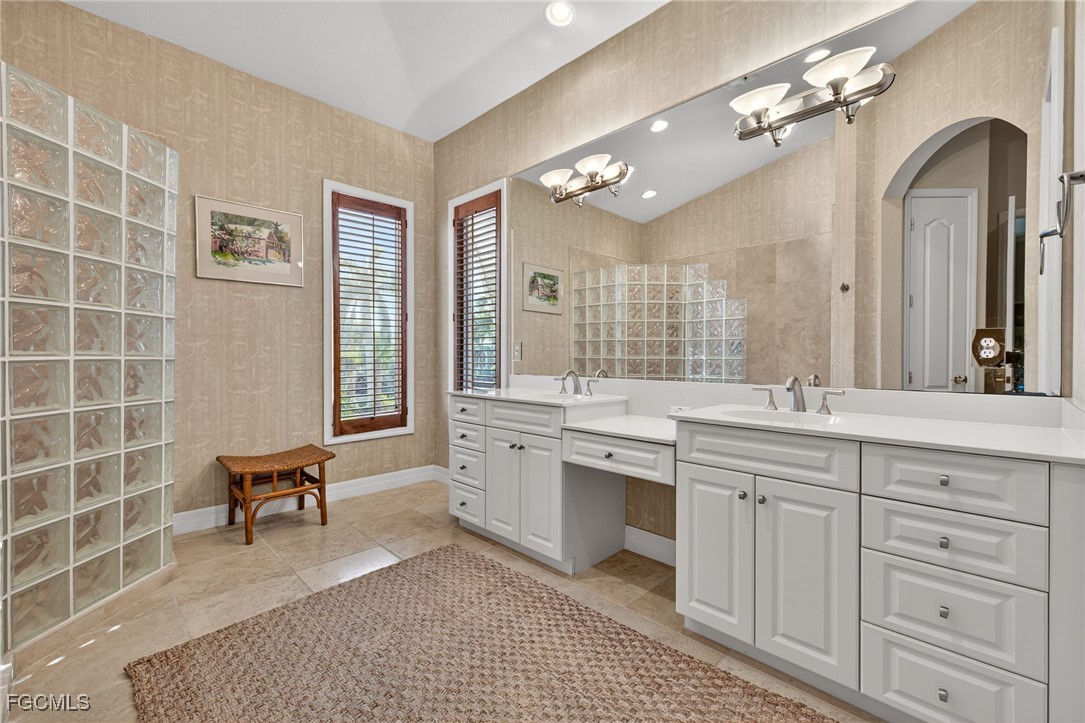 816 Birdie View Point Sanibel, FL 33957 - Photo 18 of 43 a spacious bathroom with a granite countertop sink a toilet and a mirror