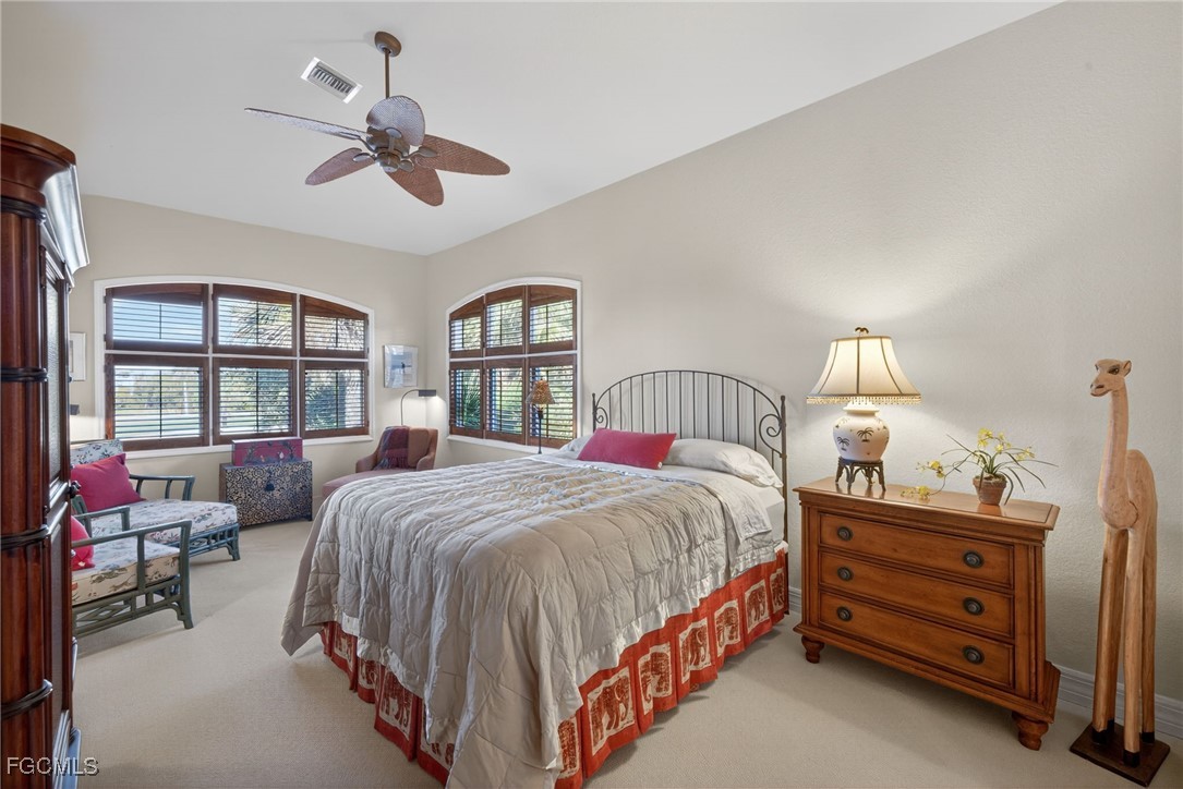 816 Birdie View Point Sanibel, FL 33957 - Photo 23 of 43 a bedroom with a bed a chandelier and dresser