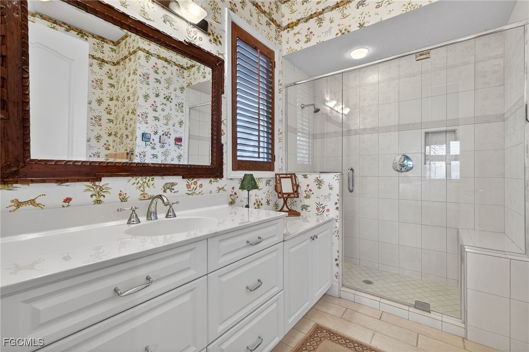 816 Birdie View Point Sanibel, FL 33957 - Photo 26 of 43 a bathroom with a double vanity sink mirror and shower