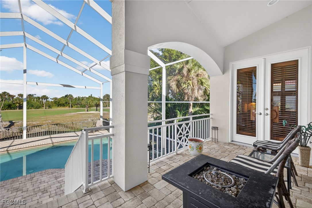 816 Birdie View Point Sanibel, FL 33957 - Photo 29 of 43 a view of a balcony with floor to ceiling windows and wooden floor