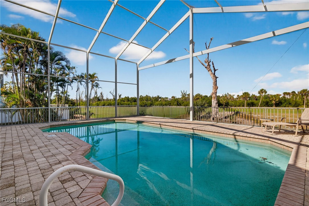 816 Birdie View Point Sanibel, FL 33957 - Photo 32 of 43 a view of a swimming pool with a porch