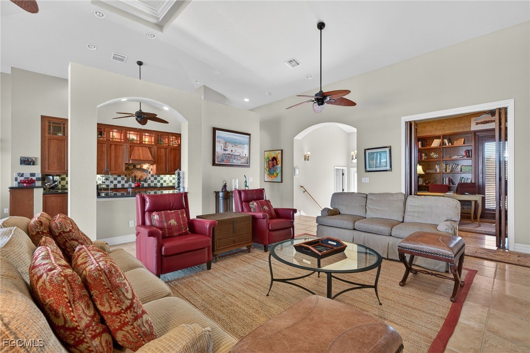 816 Birdie View Point Sanibel, FL 33957 - Photo 4 of 43 a living room with furniture a chandelier and a rug