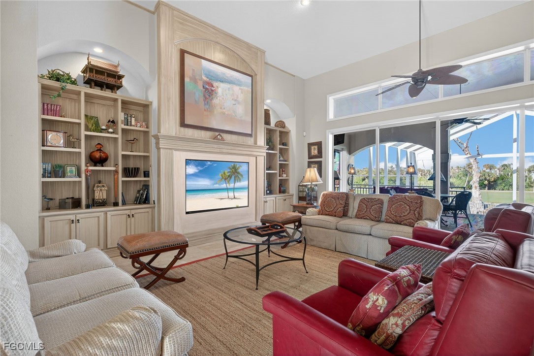 816 Birdie View Point Sanibel, FL 33957 - Photo 5 of 43 a living room with furniture a fireplace and a large window