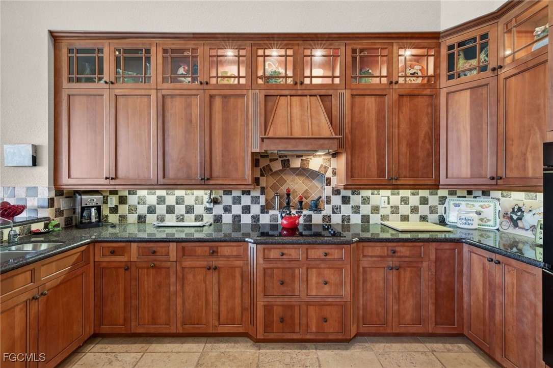 816 Birdie View Point Sanibel, FL 33957 - Photo 9 of 43 a kitchen with granite countertop a sink dishwasher stove and cabinets