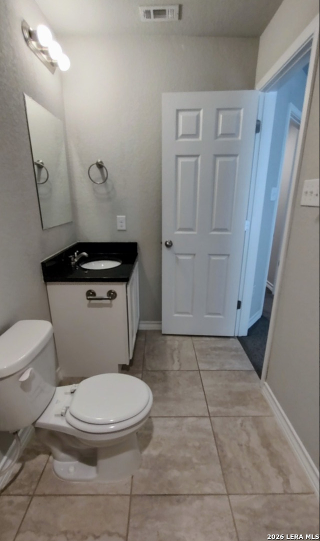 16901 Dancing Ava Selma, TX 78154 - Photo 5 of 14 a white toilet sitting next to a sink and vanity