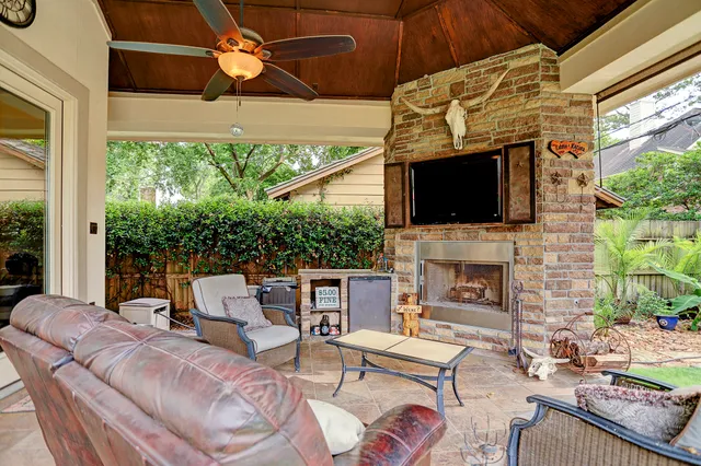 a view of a swimming pool with lawn chairs under an umbrella