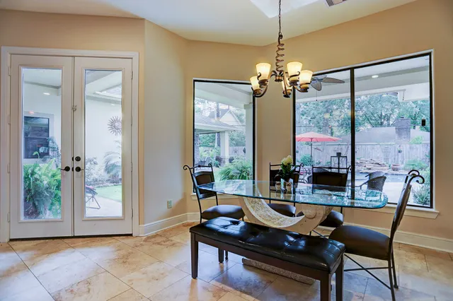 a dining room with furniture a chandelier and wooden floor