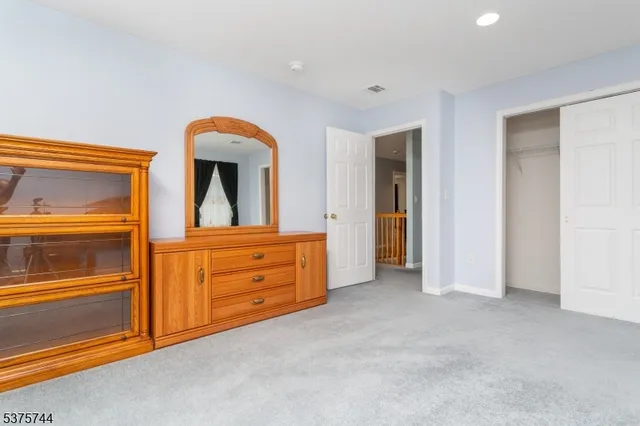 an empty room with closet and mirror