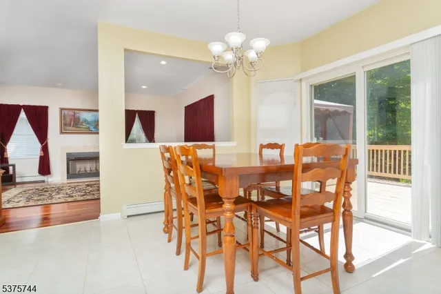 a view of a dining room with furniture and a chandelier