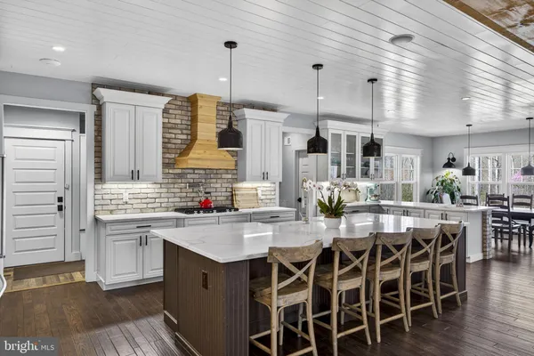 a kitchen with stainless steel appliances a stove and white cabinets
