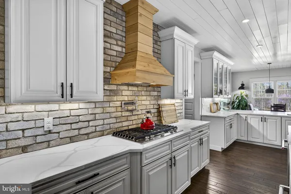 a kitchen with stainless steel appliances a sink a stove a refrigerator and cabinets