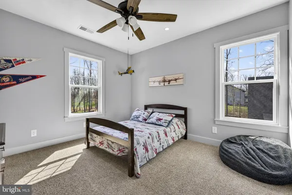 a living room with furniture a wooden floor and a flat screen tv